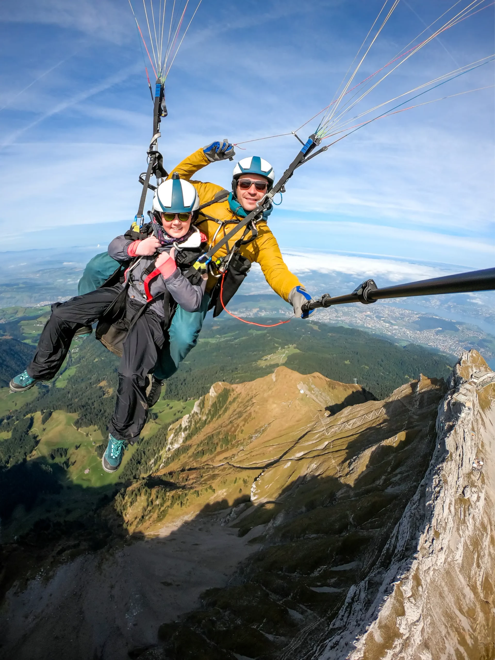 Pilot and passenger preparing for a tandem paragliding flight on Mount Pilatus